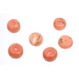 Six coral beads of circular form,