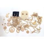 Collection of gold and yellow metal jewellery - to include charm bracelet, locket, rings, earrings,