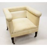 Late Victorian squat armchair of square form, raised on turned legs and ceramic castors,