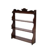 Early Victorian mahogany wall shelves with shaped cresting and four graduated shelves between