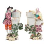Pair 18th century Chelsea porcelain figures with baskets and polychrome decoration,
