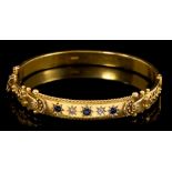 George V gold (15ct) hinged bangle with three sapphires and two rose cut diamonds in star setting