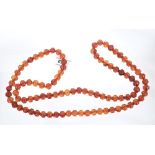 Unusual Chinese carved amber bead necklace with a string of ninety-four beads,