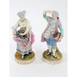 Pair late 19th century German porcelain figures holding baskets of flowers,