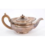 George III silver teapot of compressed campana form, with half fluted decoration, gadrooned border,