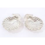 Pair Edwardian silver butter shells of conventional form, on three ball feet (Birmingham 1908),