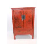 Chinese red lacquered cupboard with gilt chinoiserie ornament,