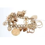 Gold (9ct) charm bracelet with numerous gold and yellow metal charms - to include a full sovereign