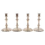 Matched set of four George II cast silver candlesticks with faceted and knopped stems and