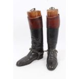 Pair of gentlemen's black leather hunting boots with brown tops and wooden trees and a pair of