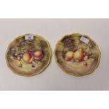Pair of Royal Worcester plates with gilt rim and hand-painted fruit decoration,