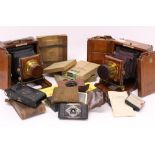 Four vintage cameras, two mahogany and brass plate cameras by J.