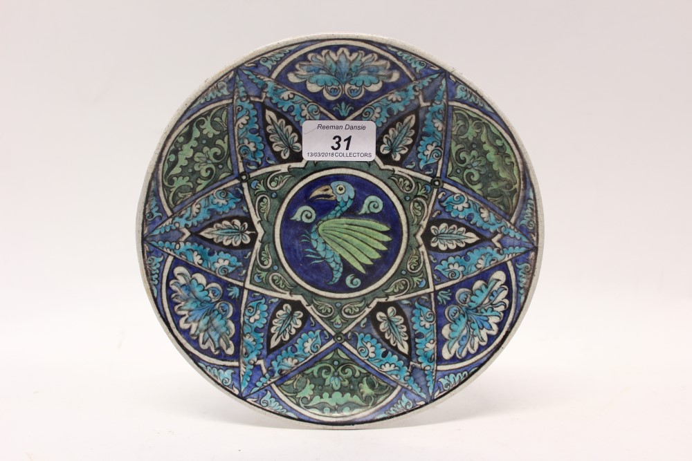 William De Morgan pottery plate decorated with Iznik-style decoration depicting a bird amongst