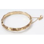 Gold (9ct) bamboo design hinged bangle with safety chain and antelope head charm