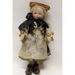 Dolls - small tinted Parian ware doll with moulded and painted features, fabric body, in silk dress,