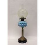 Edwardian brass oil lamp with blue glass reservoir and frosted glass shade,