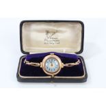 1920s ladies' rose gold cased wristwatch with guilloche enamel dial, on expandable bracelet,