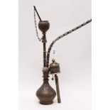 Early 20th century Indian chased and engraved copper Hookah pipe with mouthpiece, burner and tongs,