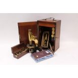 Late 19th century microscope with accessories and lenses in a mahogany case,