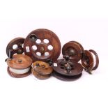 Quantity of large vintage wooden fishing reels of Scarborough and other types,