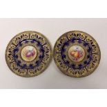 Pair of Royal Worcester plates with hand-painted fruit reserves within a gilt and cobalt-blue