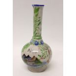 Antique Iznik pottery bottle vase decorated with scenes of buildings amongst trees, 20.