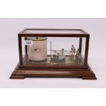 Early 20th century barograph by M.D.S. London, with spare charts, in a glazed mahogany case, 37.