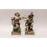 Two large pottery figures of seated men drinking,