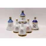 Six Wade Bells commemorative whisky decanters (five with contents)