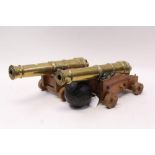 Pair of miniature cast brass cannons on wooden carriages,