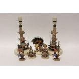 Two Hummel table lamps - each decorated with a seated figure and five other Hummel figures -