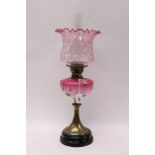 Victorian oil lamp with sun burner, pink opalescent glass reservoir with floral decoration,