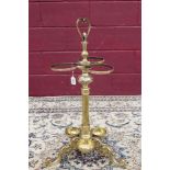 Ornate Victorian-style brass stick stand with loop handle and central knopped reeded column with