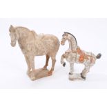 Two Chinese pottery tomb-type figures of horses - one with traces of polychrome decoration,