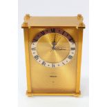Jaeger eight day musical alarm clock with gilt metal swirl dial and silvered chapter ring in a gilt