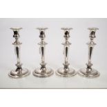 Set of four 19th century EPNS candlesticks with tapering columns, gadrooned borders,