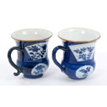 Pair 18th century Chinese Kangxi blue and white cups of bellied form, with scroll handles,