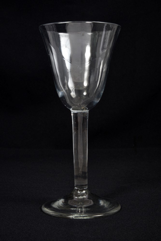 Large mid-18th century Georgian wine goblet with funnel bowl, plain stem on splayed foot,