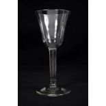 Large mid-18th century Georgian wine goblet with funnel bowl, plain stem on splayed foot,