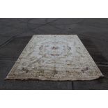 Large French-style carpet with cream ground and central floral bouquet with radiating scroll and