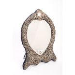 Edwardian silver mounted dressing table mirror of waisted form, with rococo scroll,