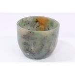Green jade vessel of slightly tapering form, mottled-green colour with russet inclusions,