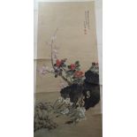 Mid-20th century Chinese scroll painting depicting a rocky outcrop with flowering shrubs,