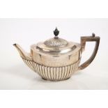 Victorian silver teapot of oval form, with half-fluted decoration,