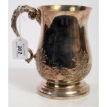 Large 19th century white metal mug of baluster form, with embossed foliate decoration,