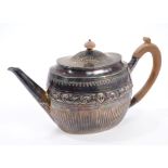 Victorian silver teapot of oval form, with half-fluted decoration and embossed foliate band,