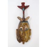 Old African carved wooden tribal mask with polychrome painted decoration,