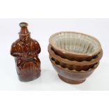 A 19th century salt glazed stoneware flask of a man astride a barrel,
