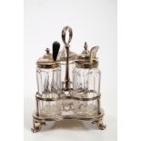 George IV silver three-bottle cruet stand of trefoil form, with central ring handle,