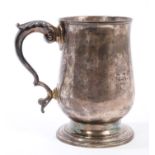 George III silver mug of baluster form, with leaf mounted scroll handle,
